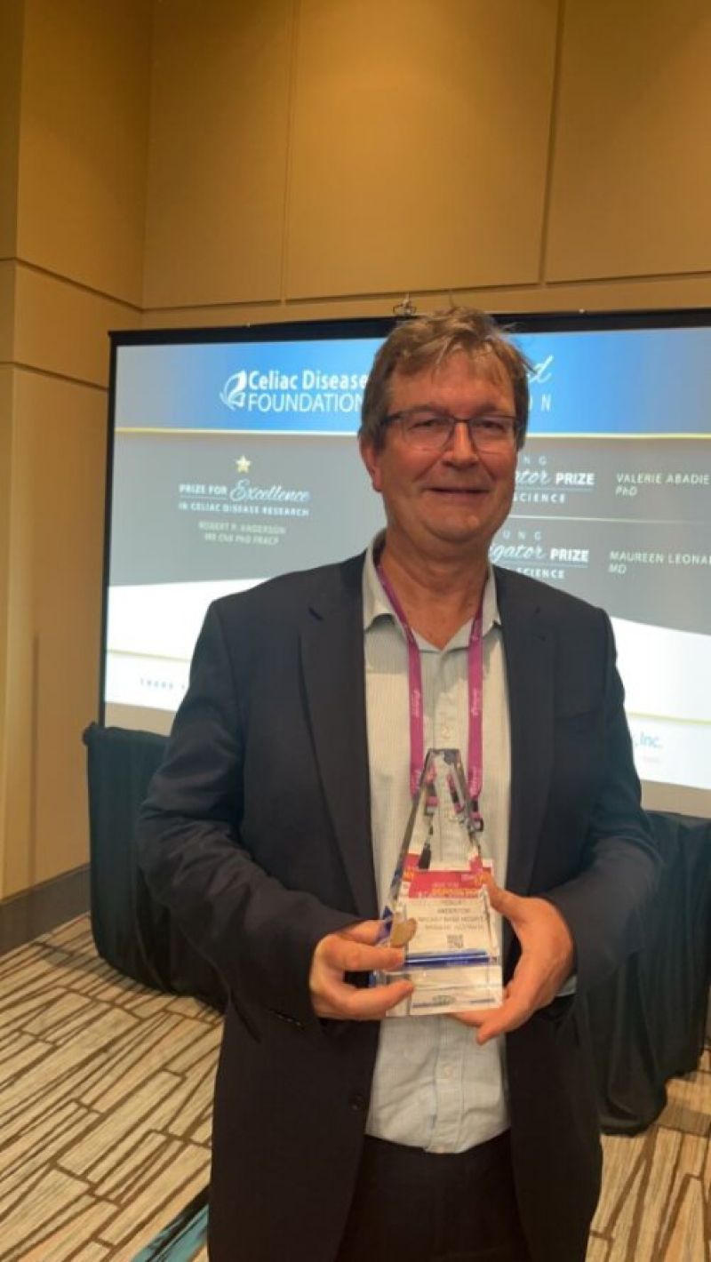 Dr Robert Anderson holding his international award for Excellence in Coeliac Disease Research  